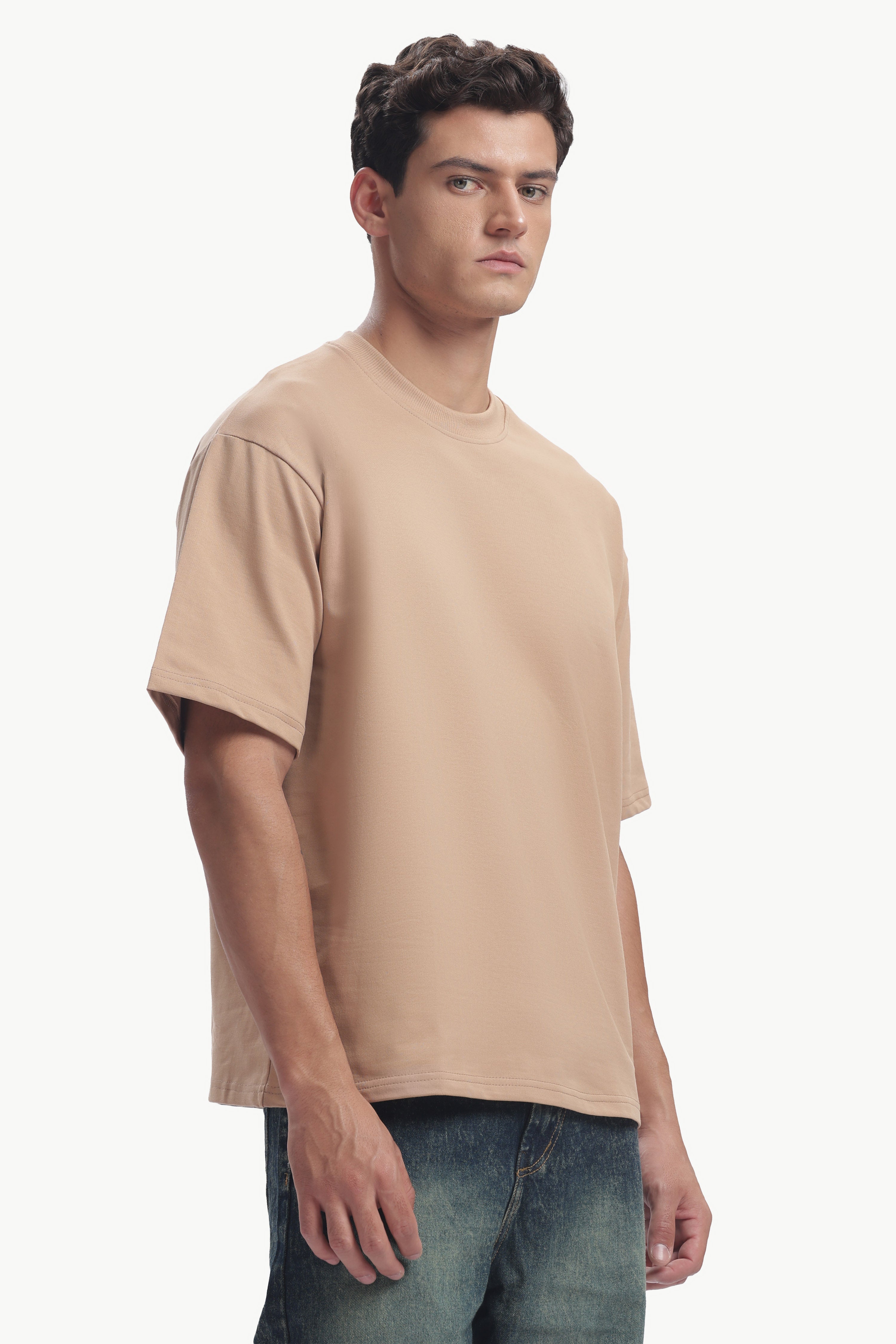 Model wearing an Oversized Fit Focal Point T-Shirt in beige, showcasing its relaxed silhouette and comfortable fit.