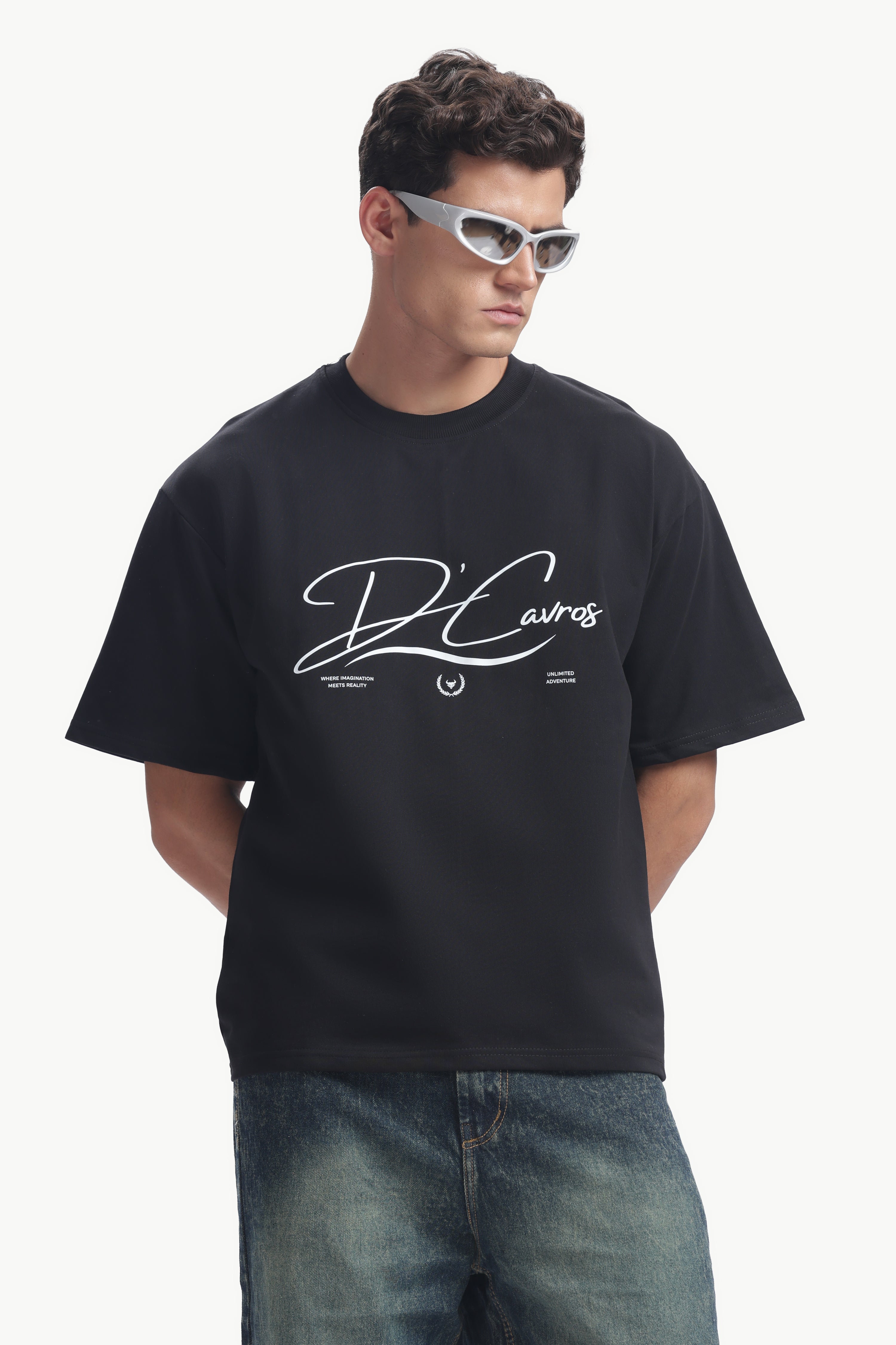 Community Capsule Graphics Tee worn by a model, featuring bold typography and a relaxed fit in modern street style.