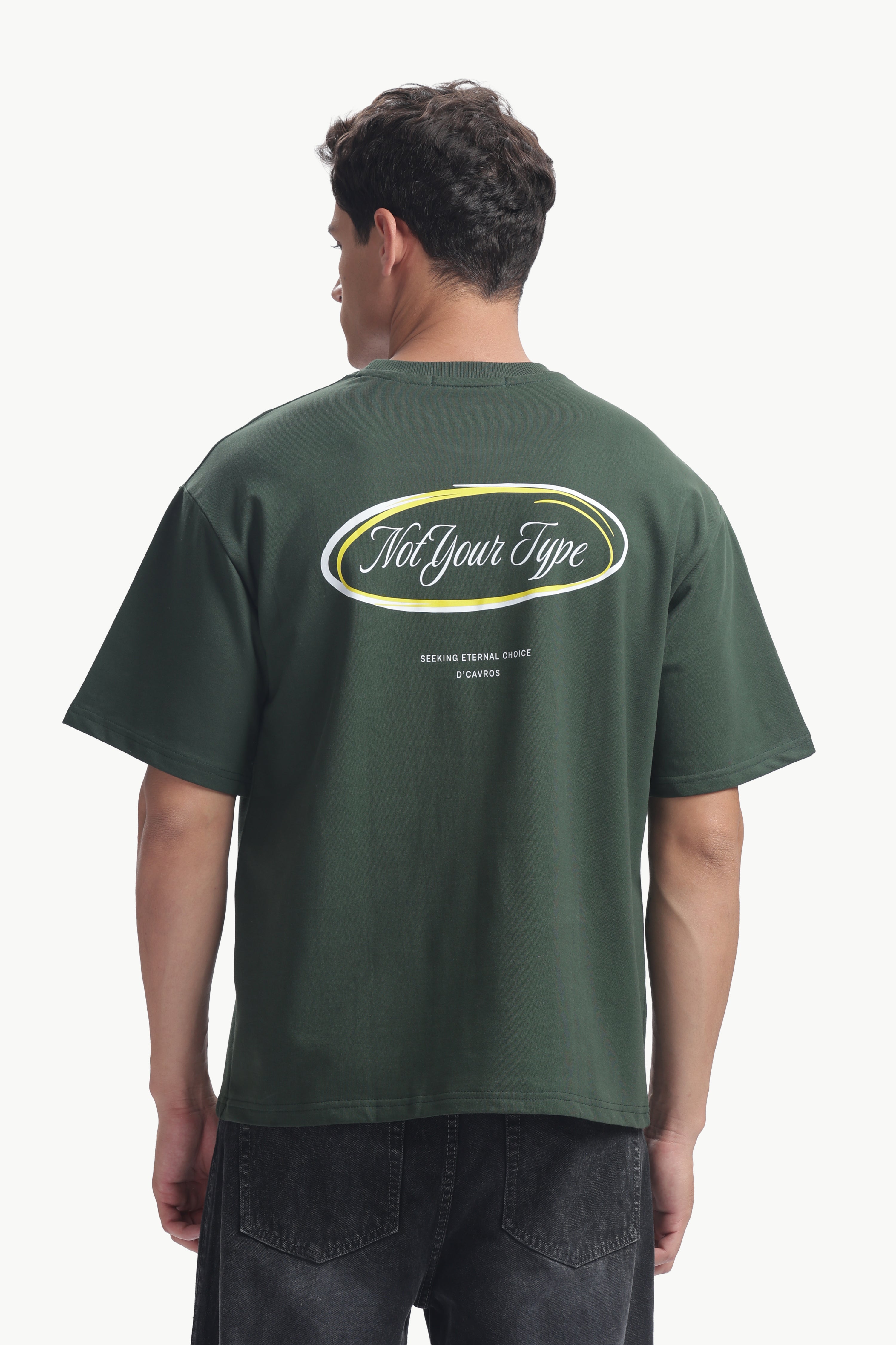 Back view of a man wearing the Not Your Type Oversized Fit Tee in green, showcasing its bold graphic design.