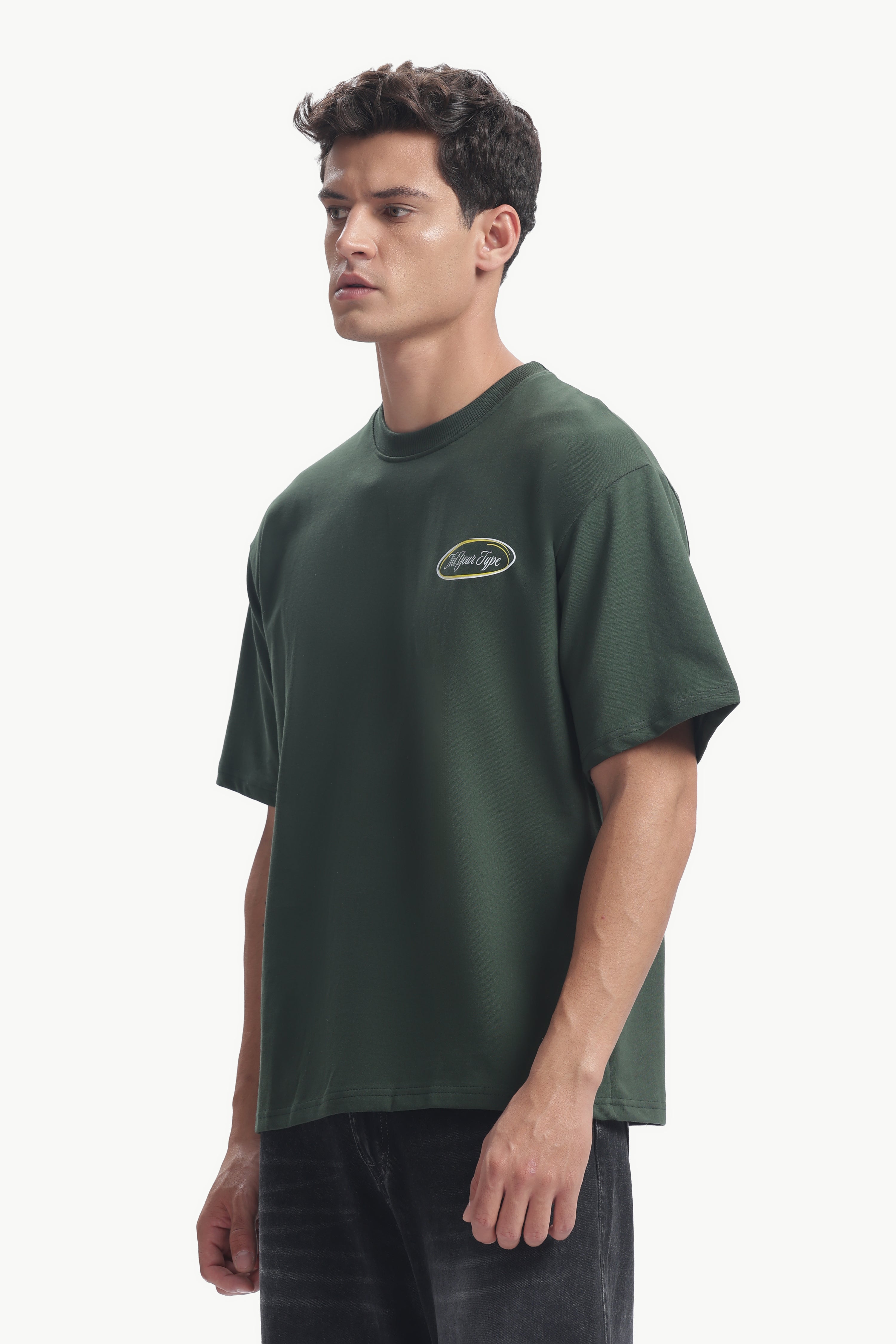 Model wearing the Not Your Type Oversized Fit Tee in dark green, showcasing its relaxed silhouette and comfortable design.