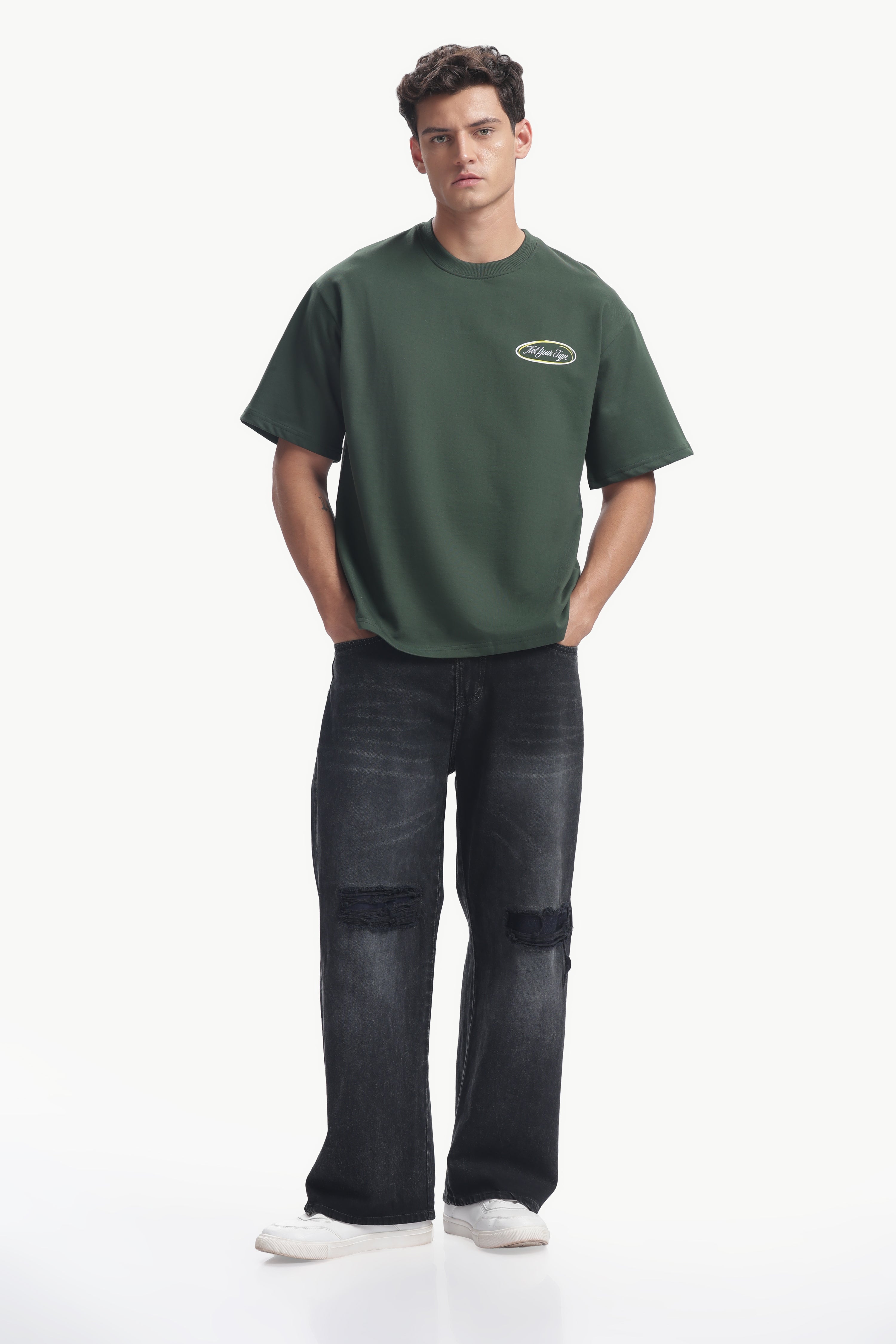 Not Your Type Oversized Fit Tee worn by a model in a relaxed outfit featuring a green tee and black jeans.