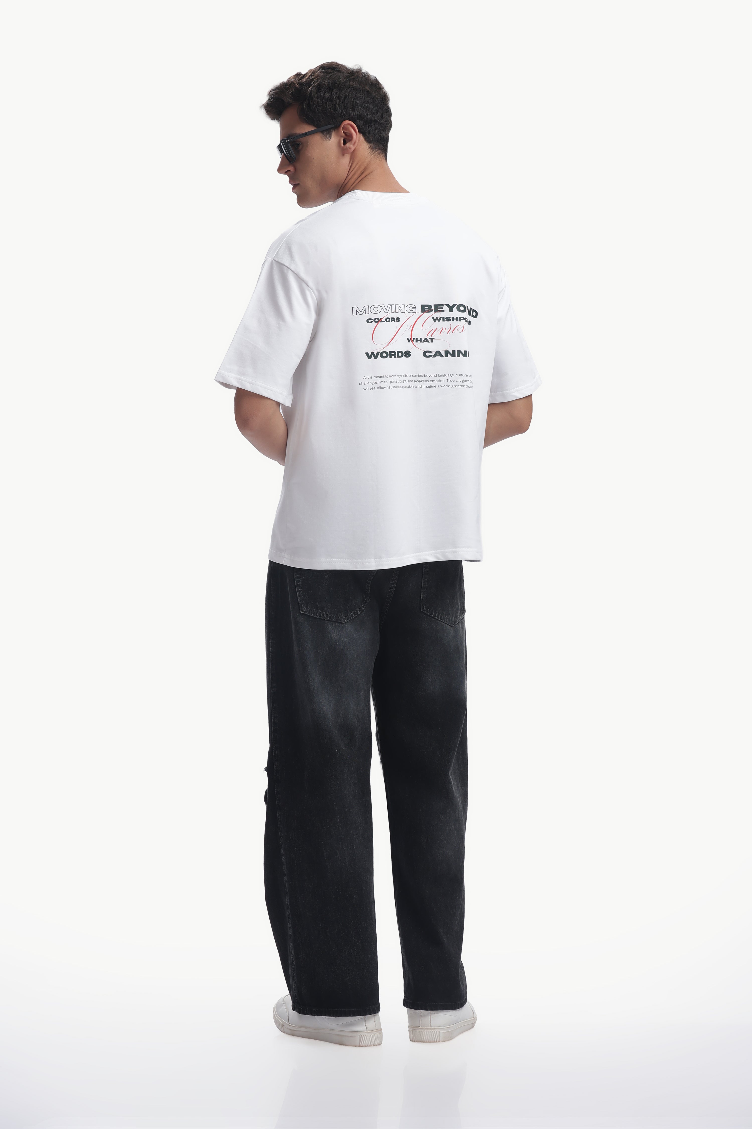 Model showcasing a Loose Fit Solid Printed T-Shirt with bold typography from the back view.