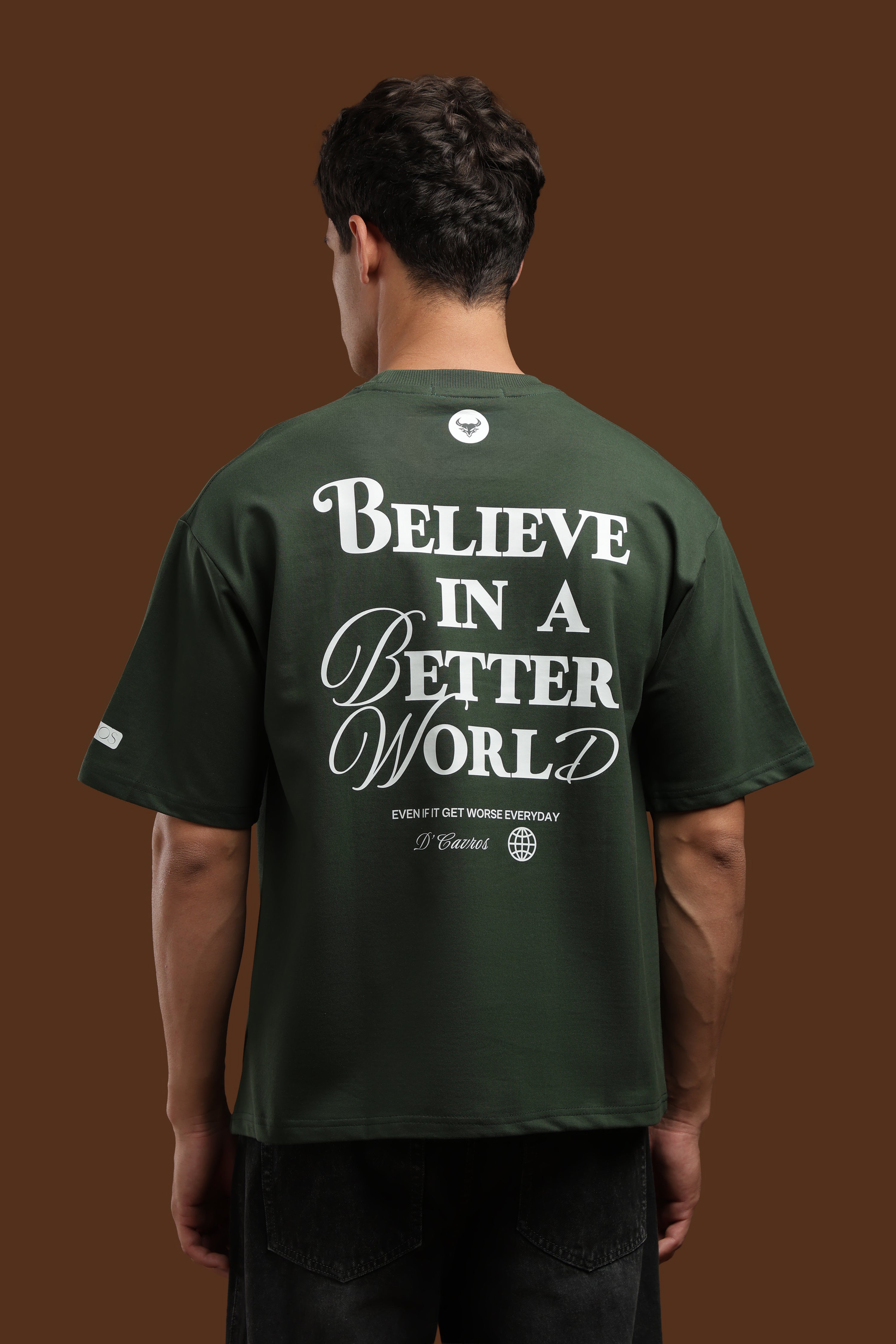 Back view of a man wearing a Better World Printed Oversized T-Shirt with a motivational print.