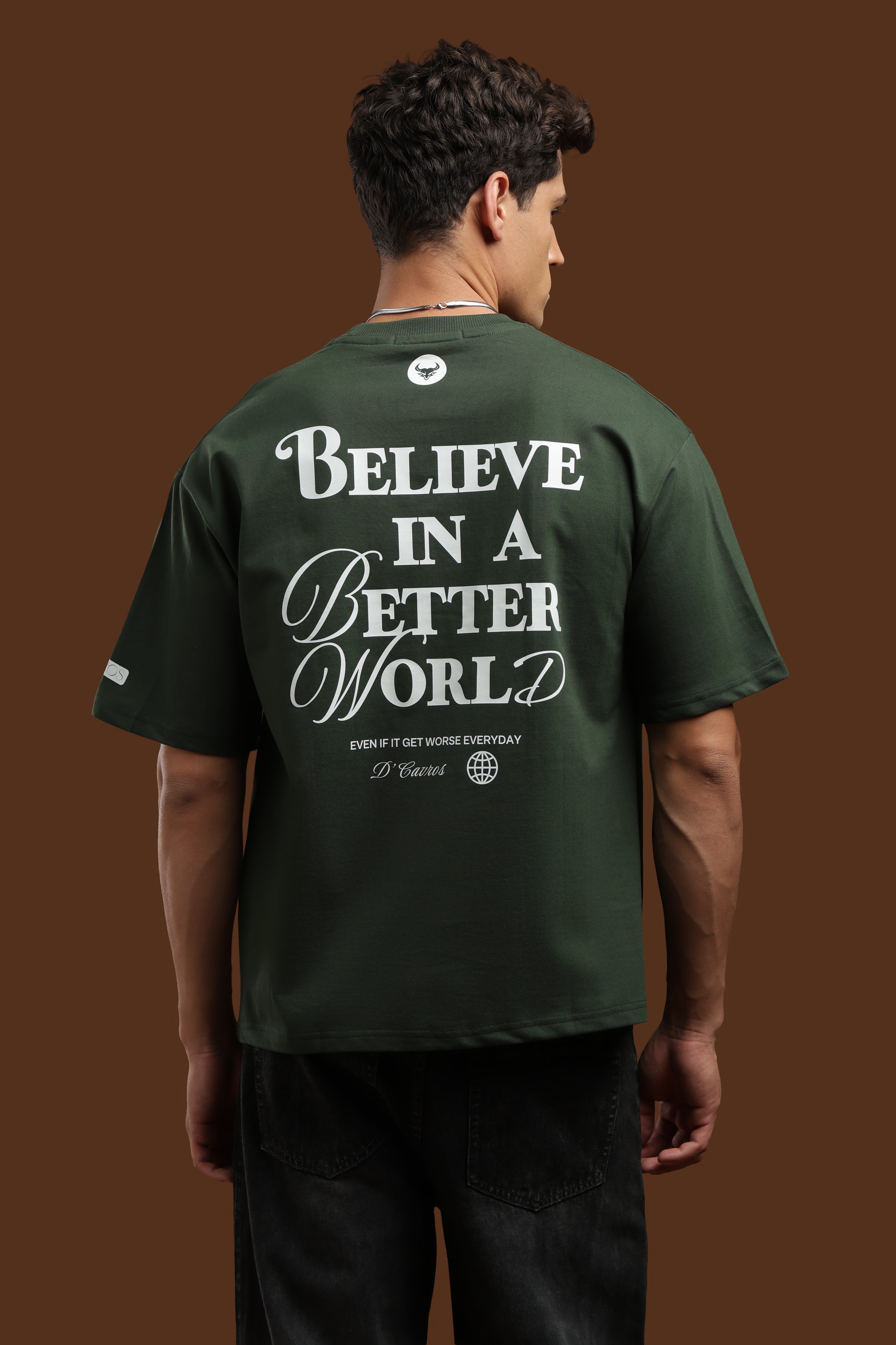 Model wearing Better World Printed Oversized T-Shirt featuring back print 'Believe in a Better World'.