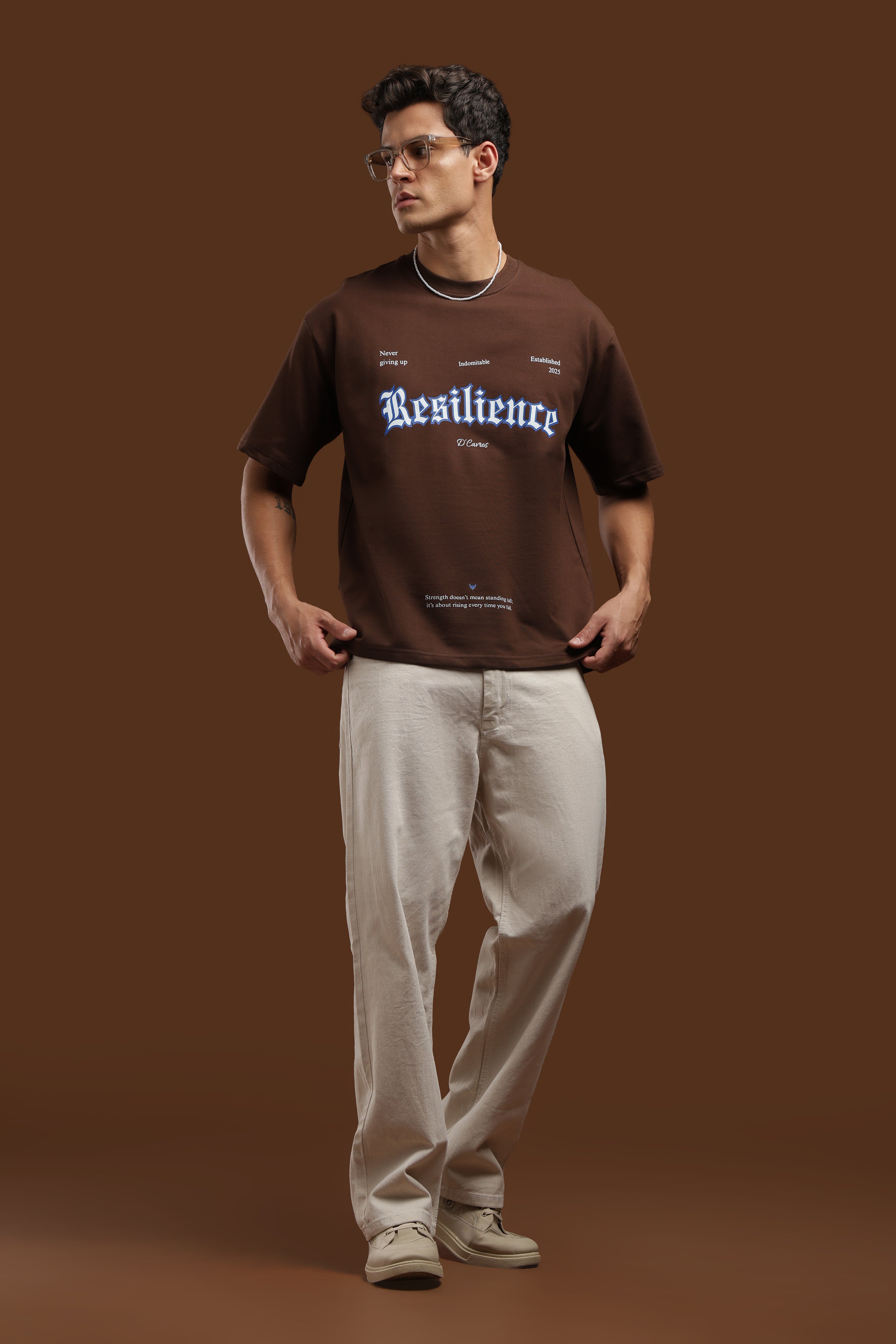 Model wearing Loose Fit Resilience Printed T-Shirt with bold typography and relaxed fit.