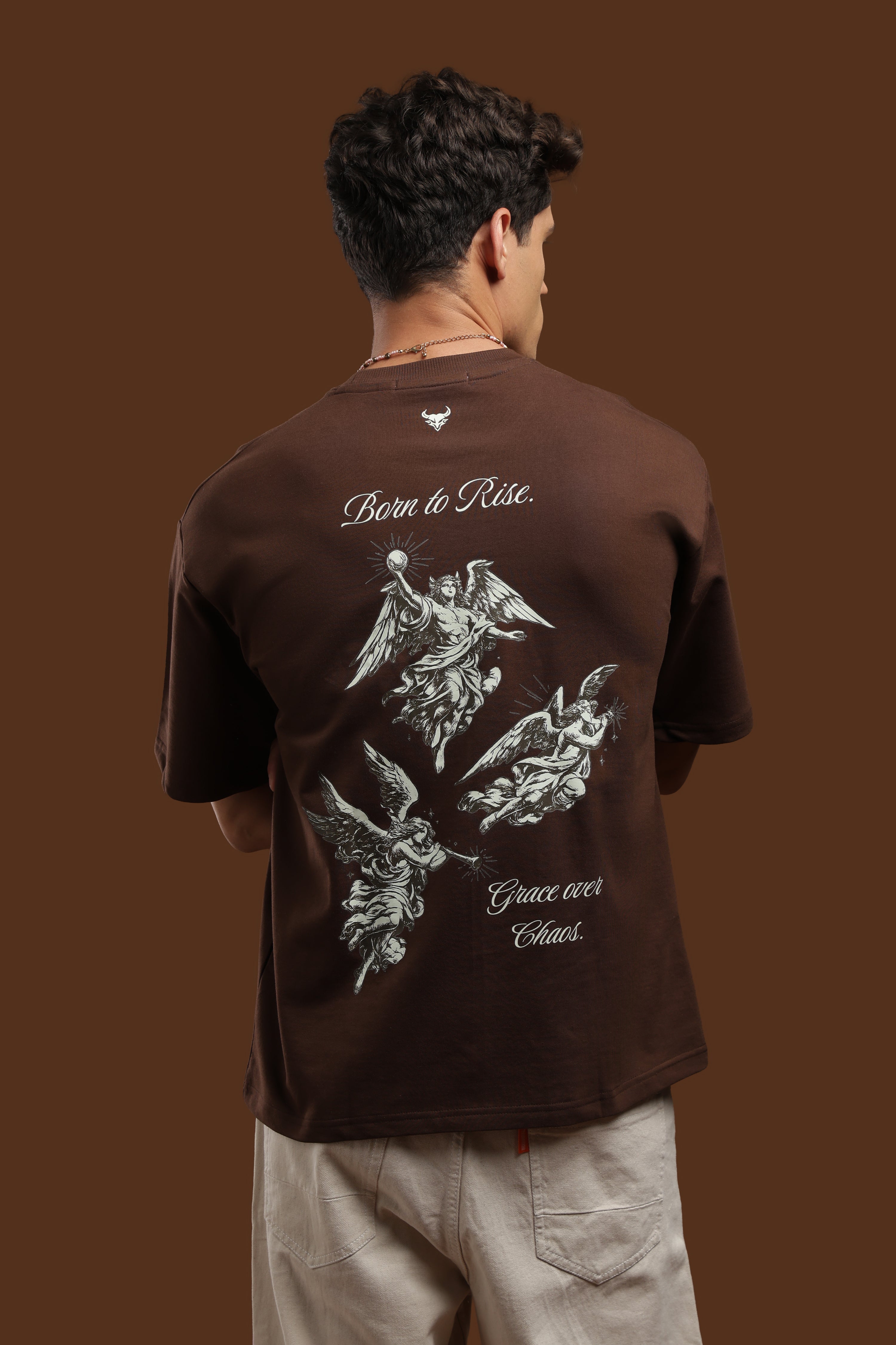 Oversized Fit Graphics Printed T-Shirt featuring bold angel artwork on a brown background.