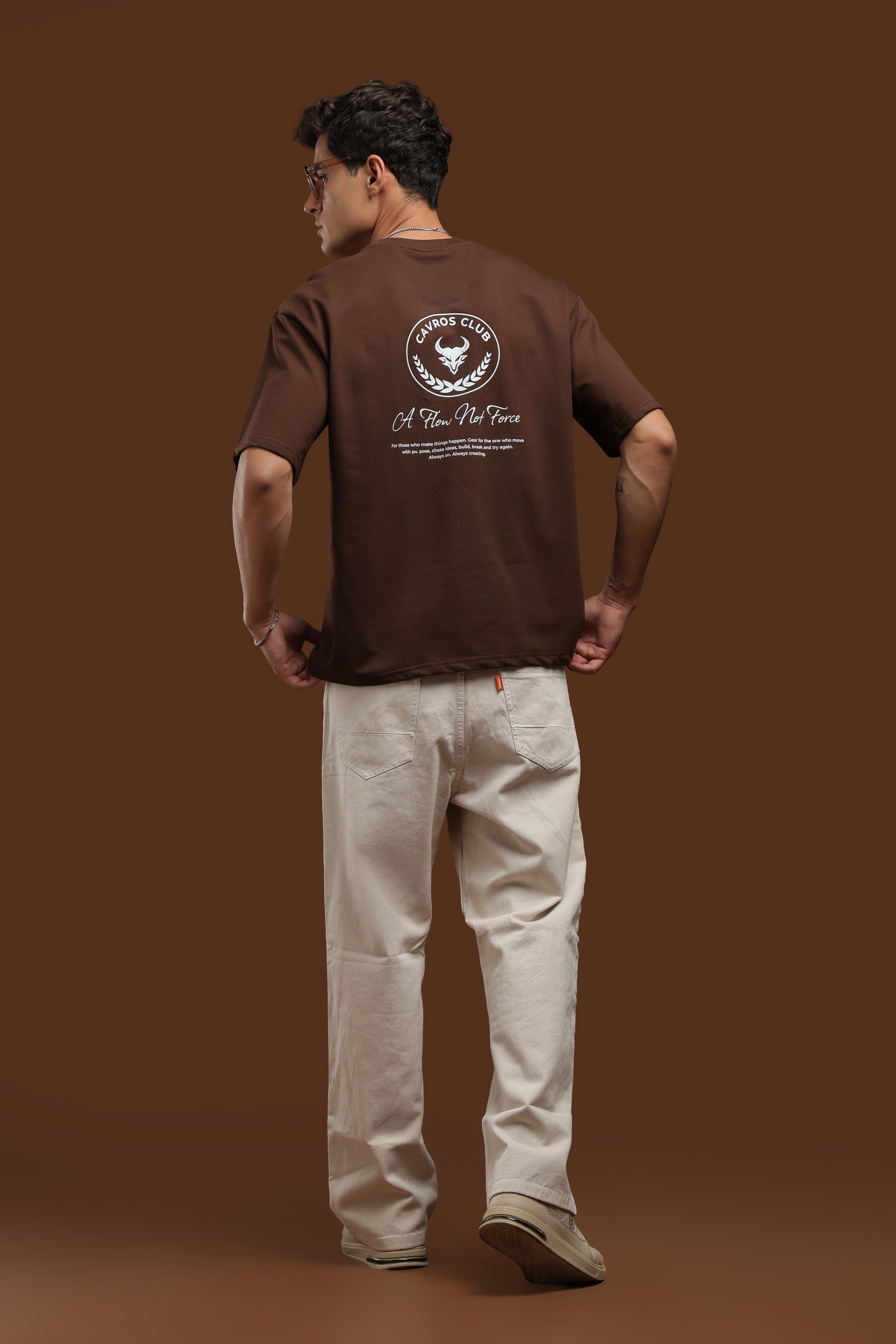 Model wearing Oversized Fit Club Printed T-Shirt with bold graphics, paired with relaxed fit pants.