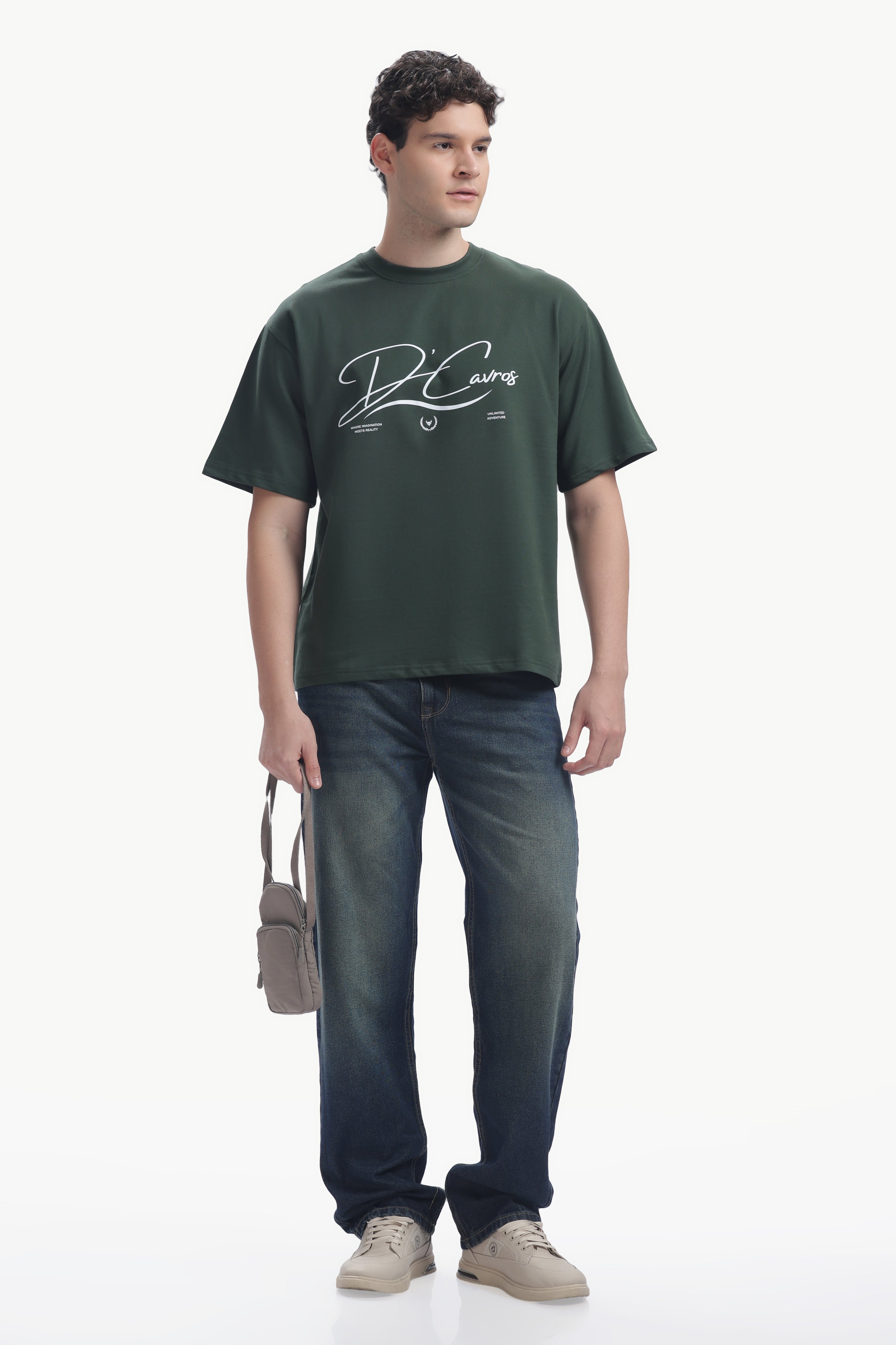 Man wearing Community Capsule Graphics Tee with bold typography and relaxed fit, paired with jeans and sneakers.