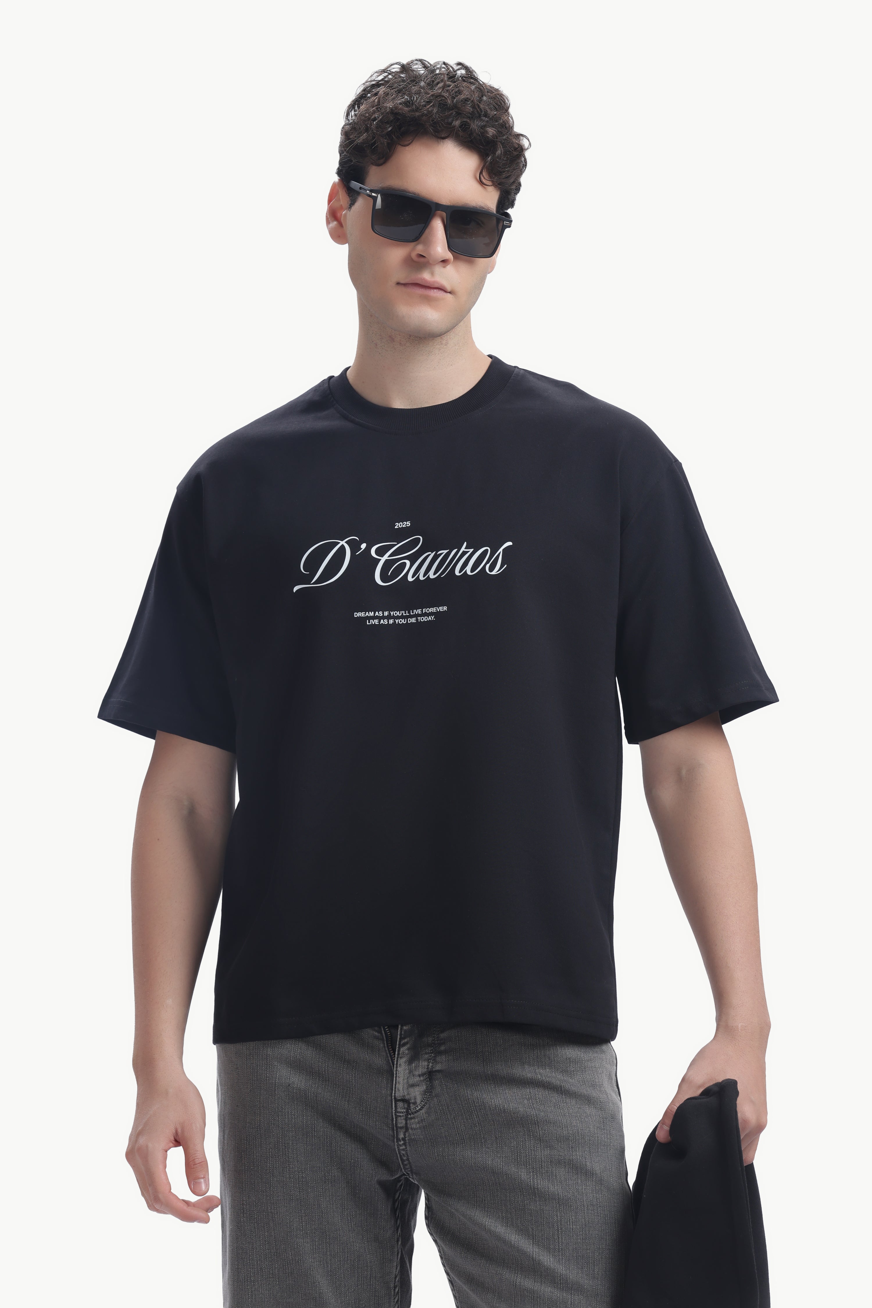 Model wearing Classic Loose Fit Typography T-Shirt with D'Cavros script and sunglasses.