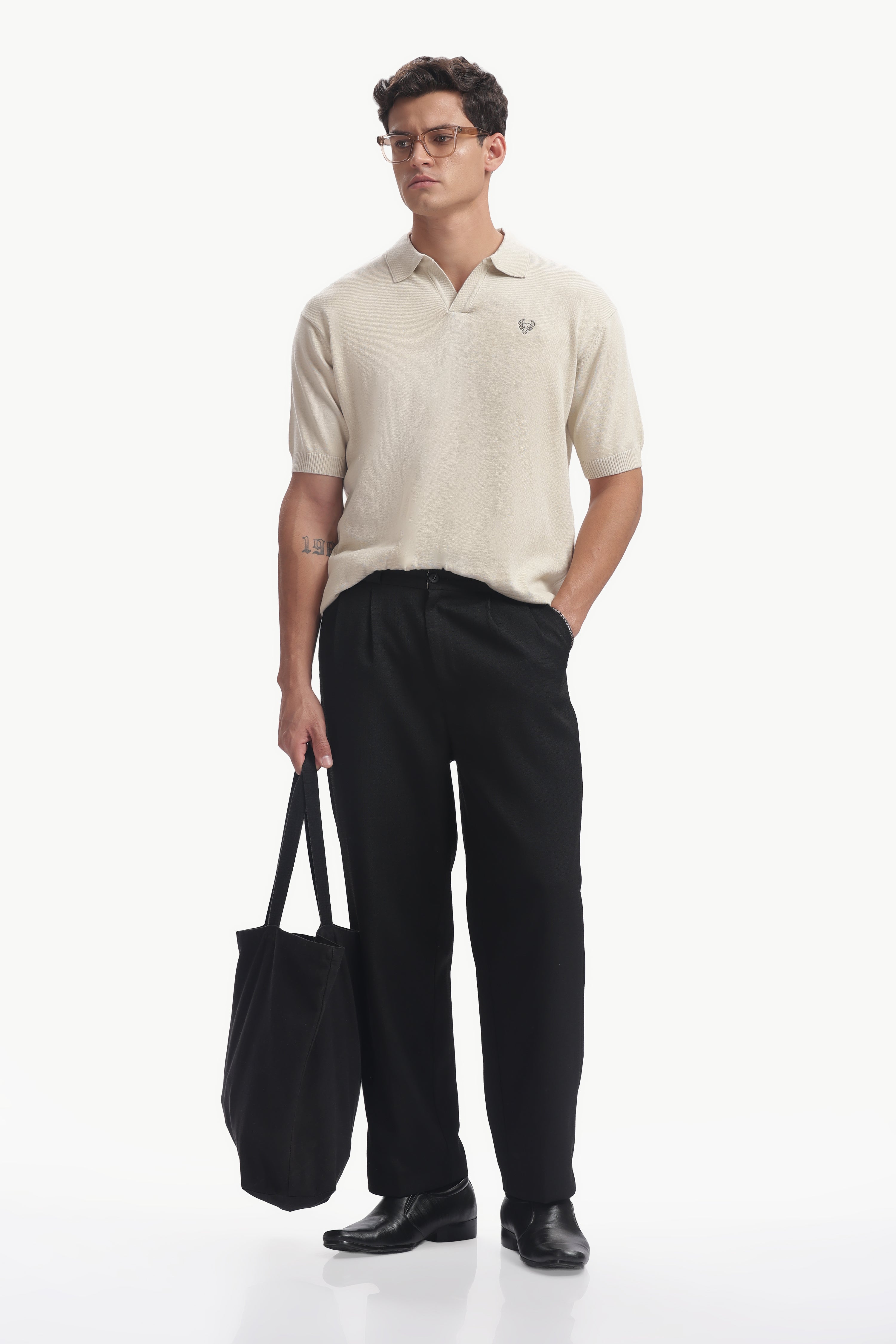 Model wearing a Classic Cotton-Knit Polo Shirt with minimalist embroidery and black trousers.
