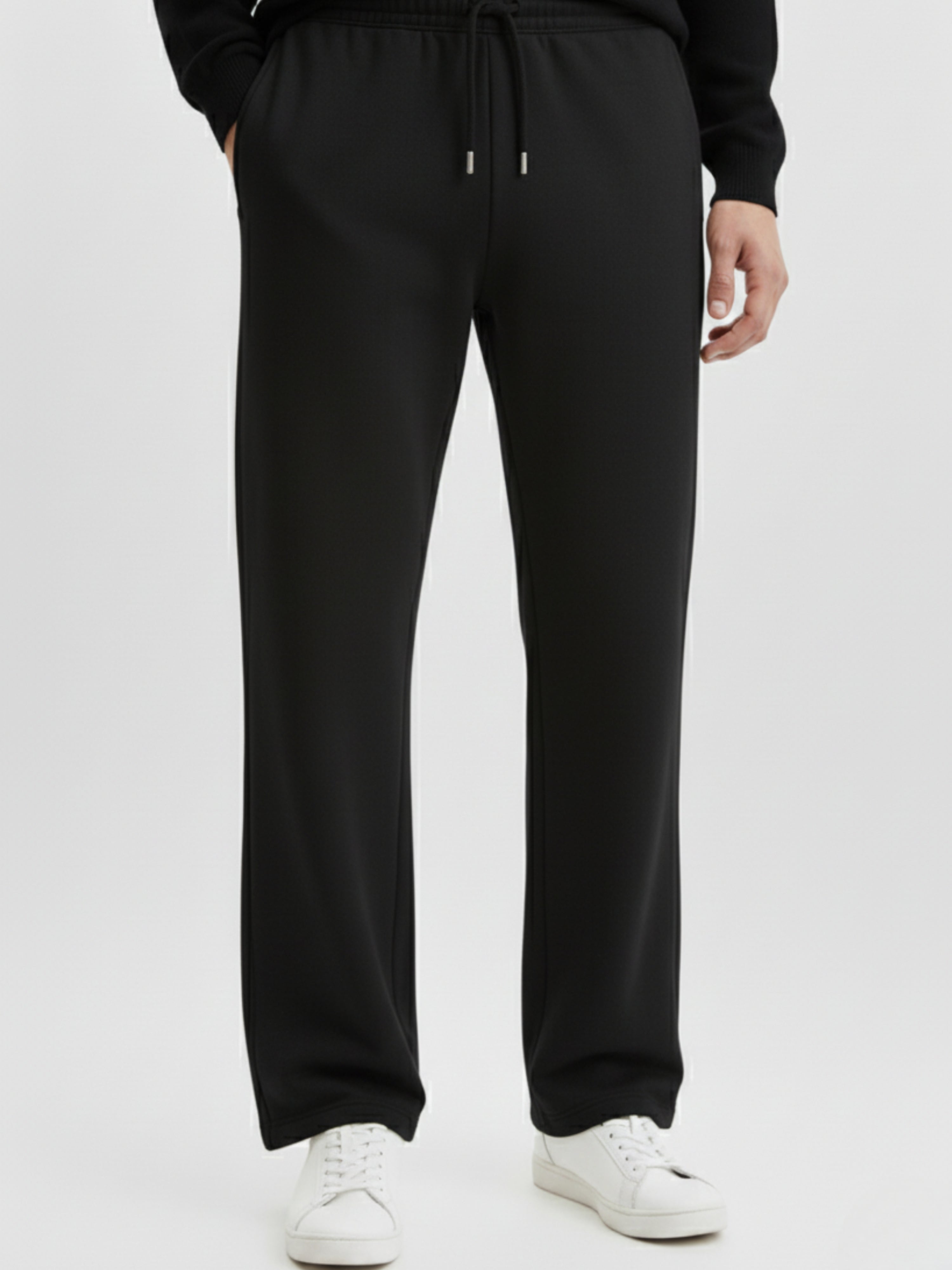 Person wearing black sweatpants on a white background