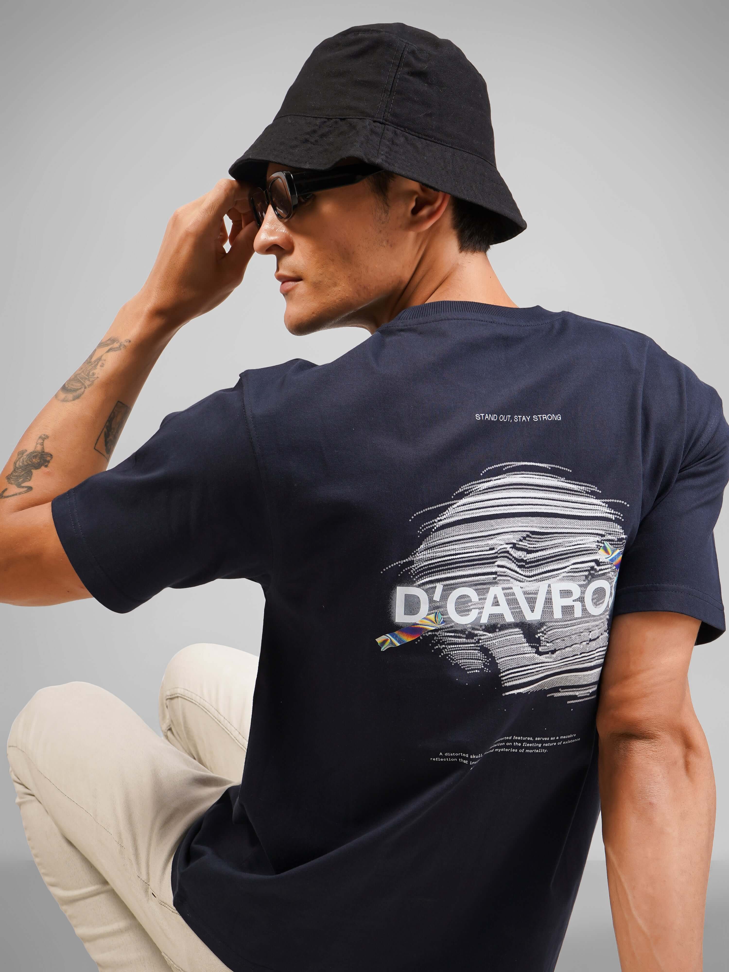 Model wearing The Skull Creature t-shirt, featuring a unique graphic on the back and a minimalist design.