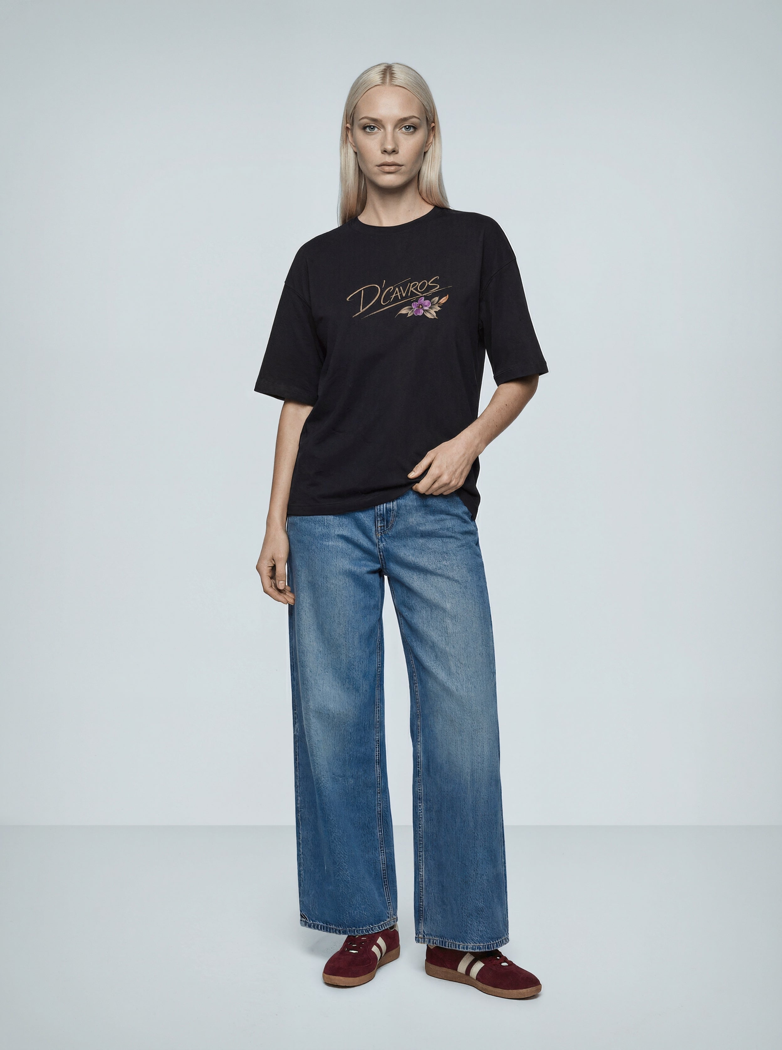 Model wearing an Oversized Printed-Frames T-Shirt by D’Cavros, styled with wide-leg jeans.
