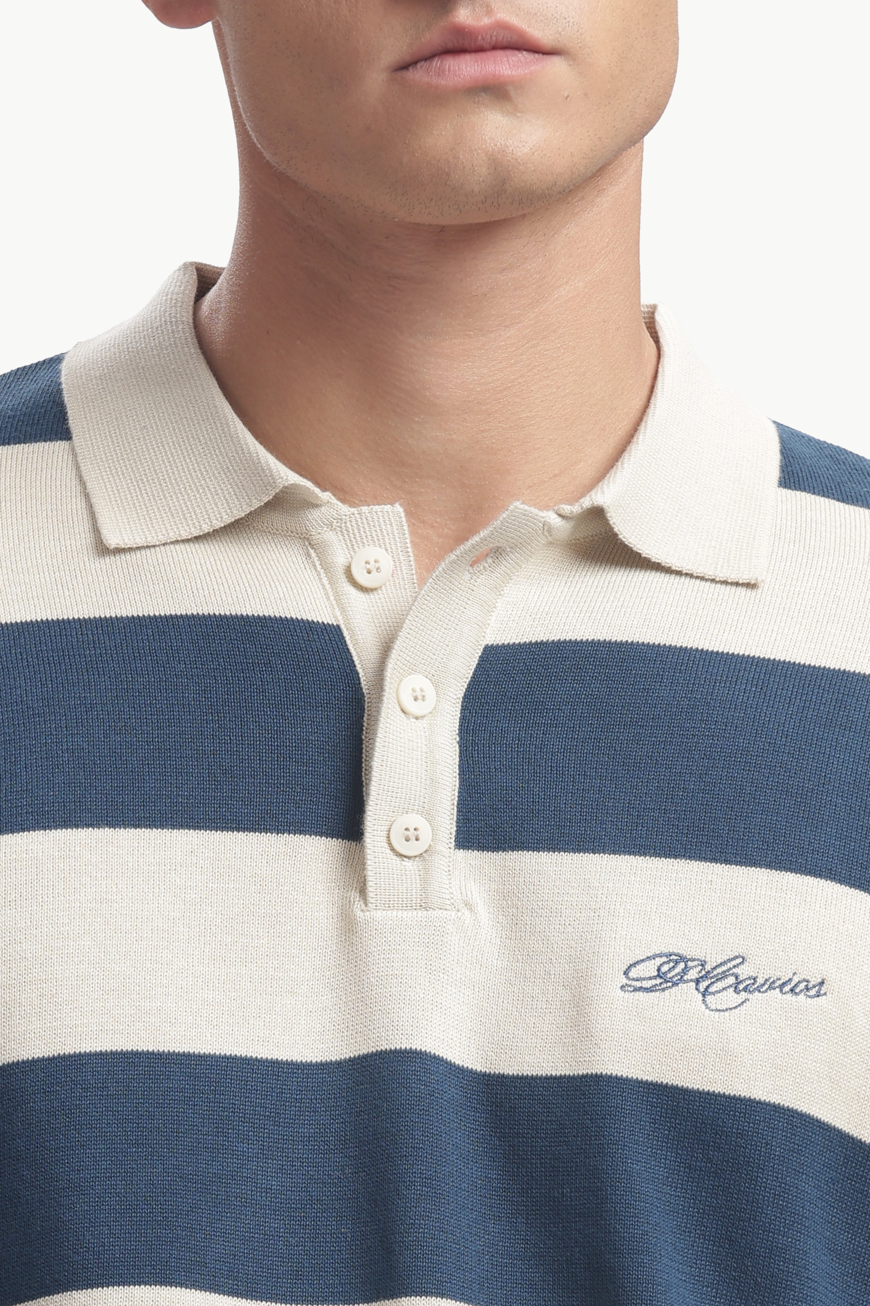 Close-up of a man wearing a Regular Fit Cotton-Knit Rugby Shirt with bold stripes and structured collar.
