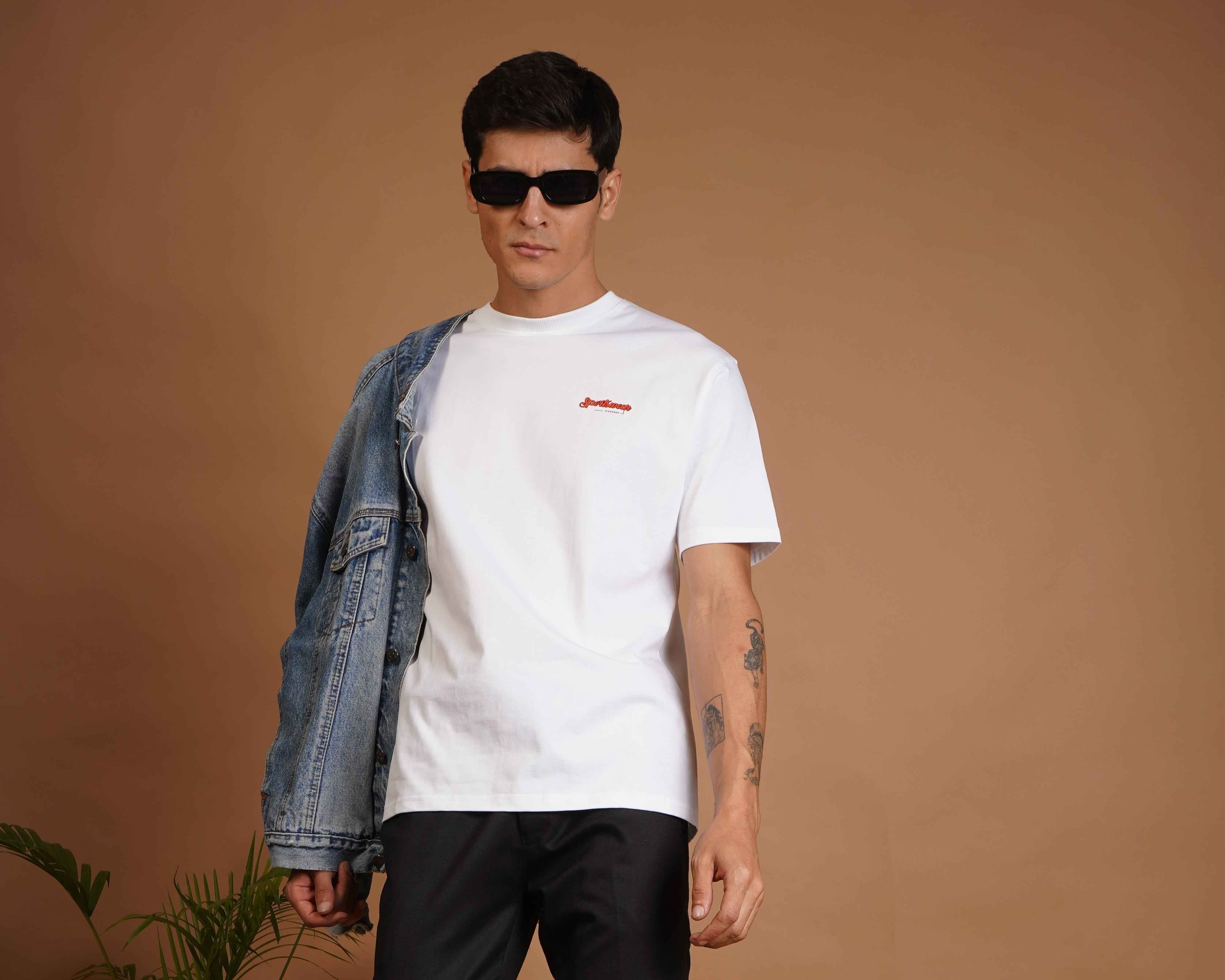 Model wearing a stylish white t-shirt with a denim jacket, showcasing upcycled fashion.