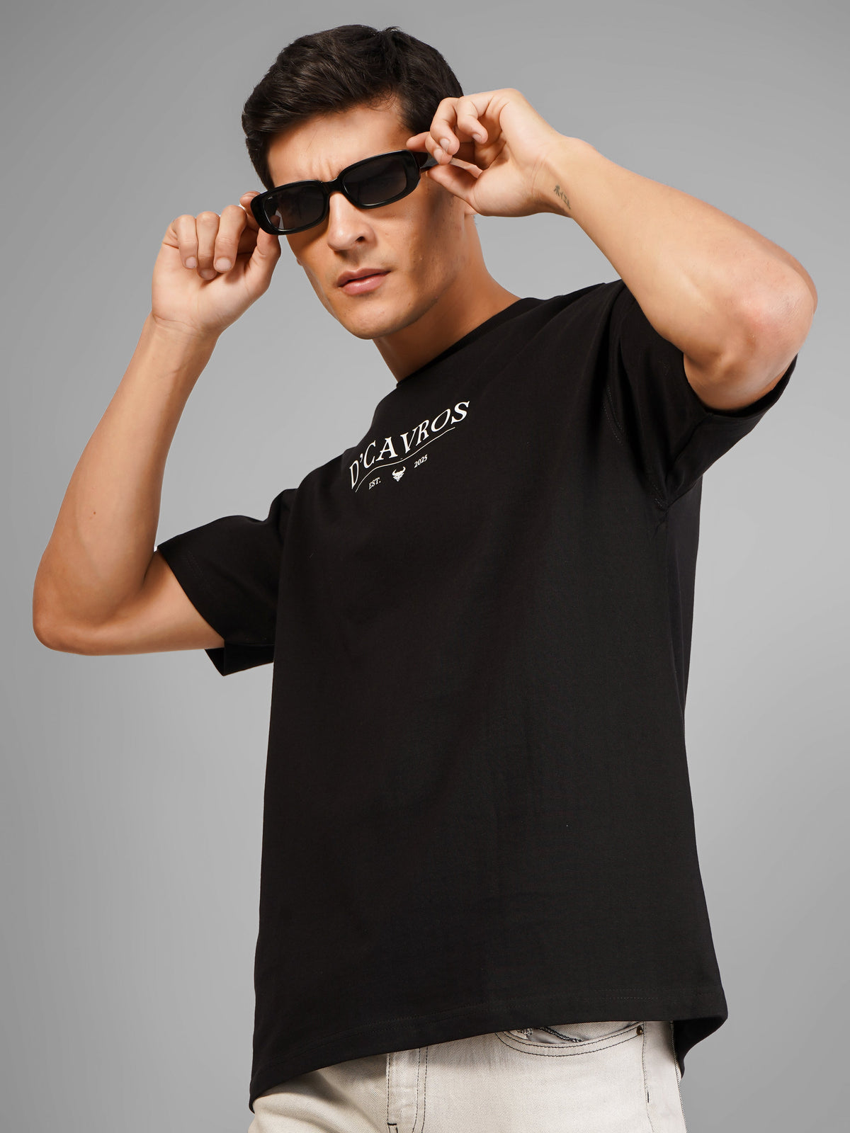 Man wearing a premium heavyweight black cotton T-shirt demonstrating quality construction.