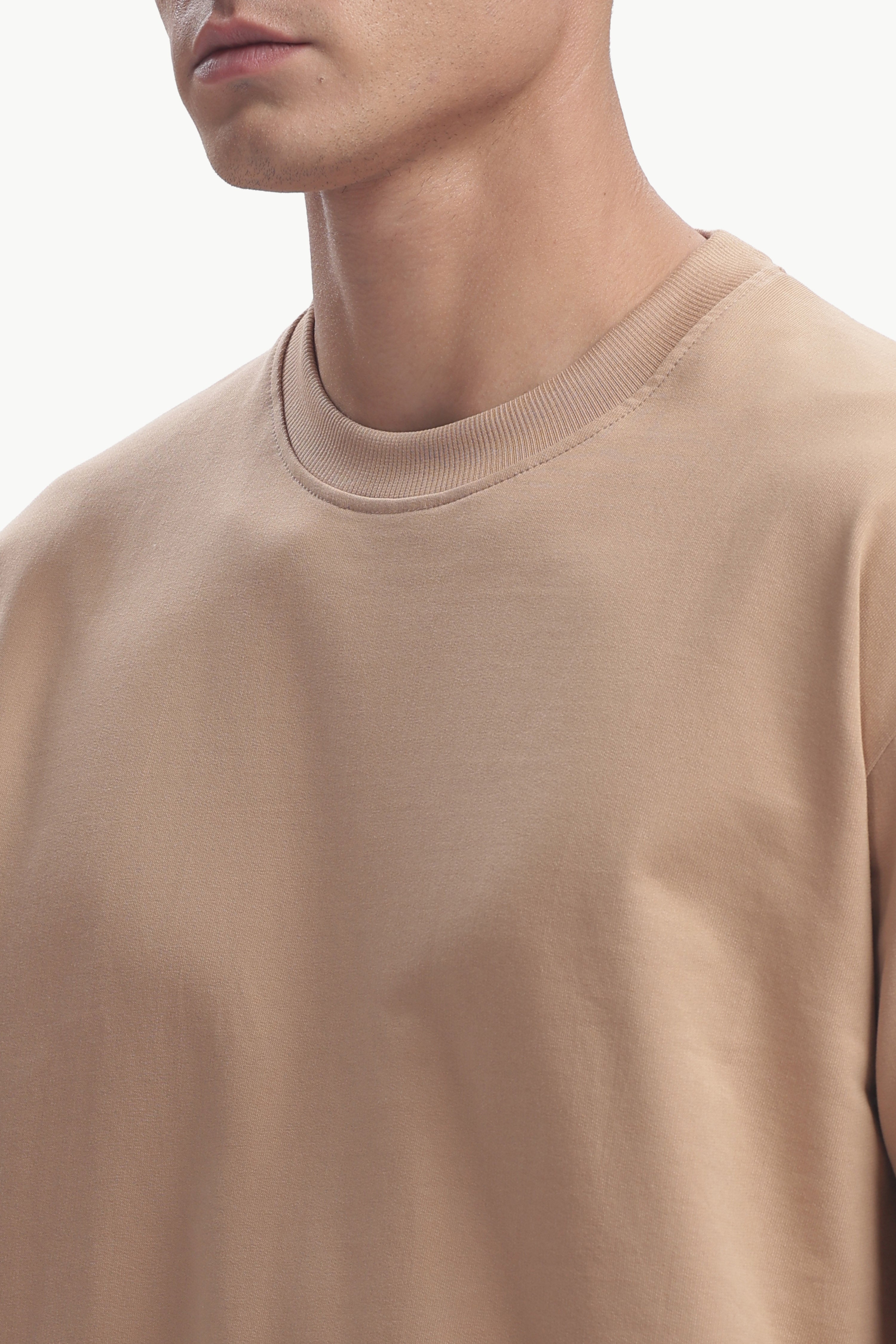 Close-up of the Oversized Fit Focal Point T-Shirt in a soft beige color, showcasing relaxed fit and comfortable fabric.