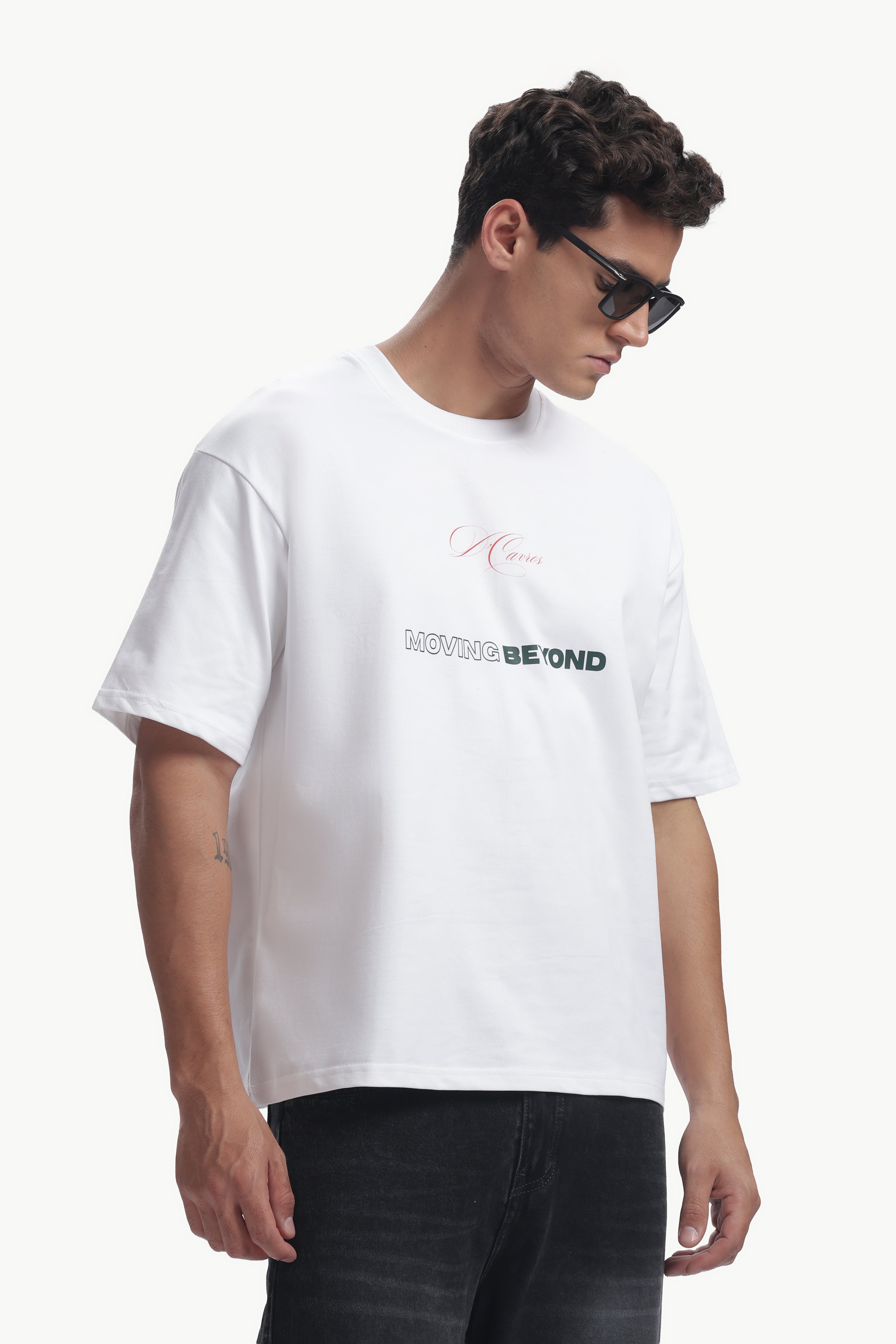 Loose Fit Solid Printed T-Shirt displayed on model wearing sunglasses, featuring bold typography.