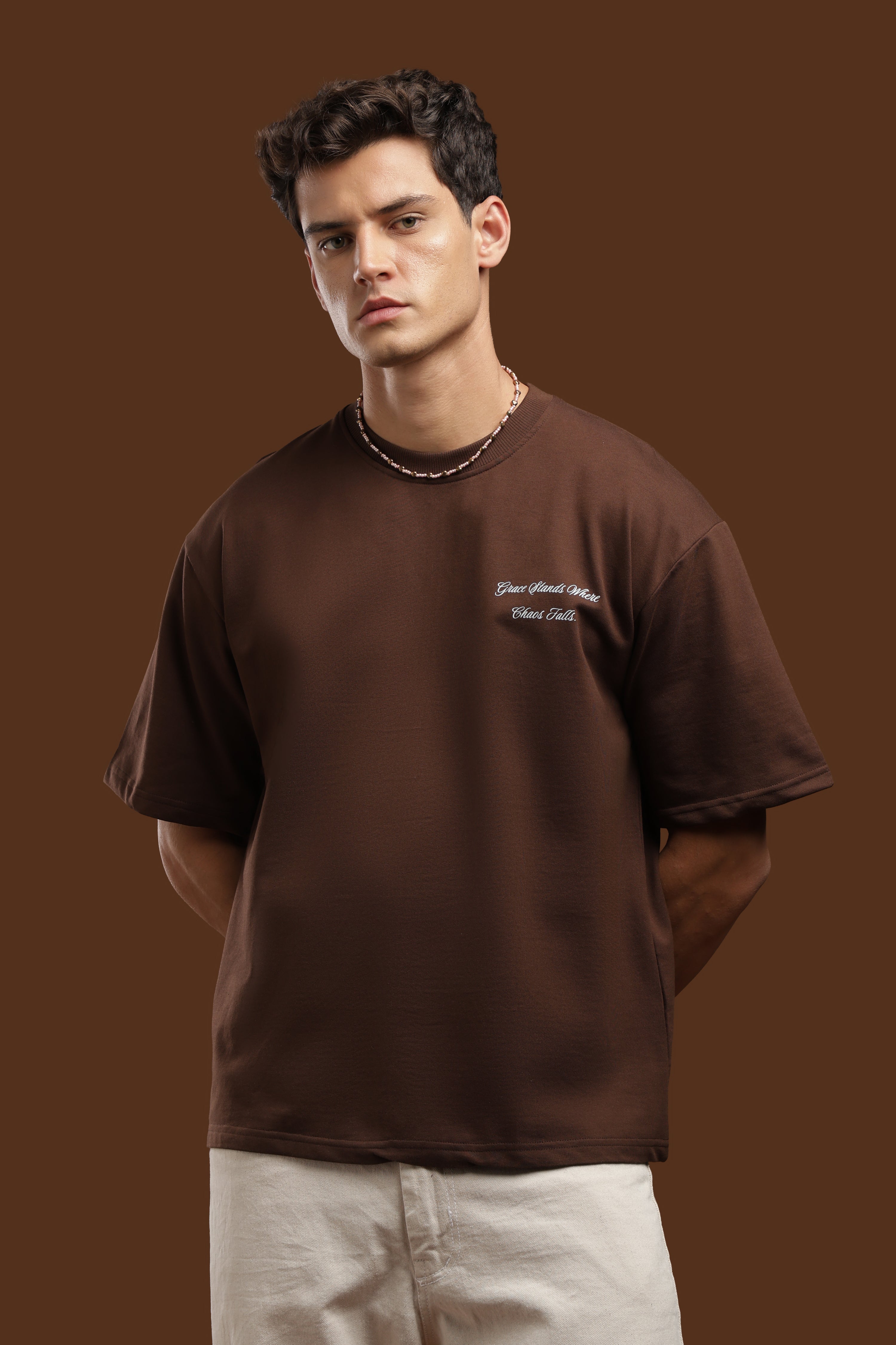 Oversized Fit Graphics Printed T-Shirt in brown color worn by a male model with relaxed fit and stylish design.