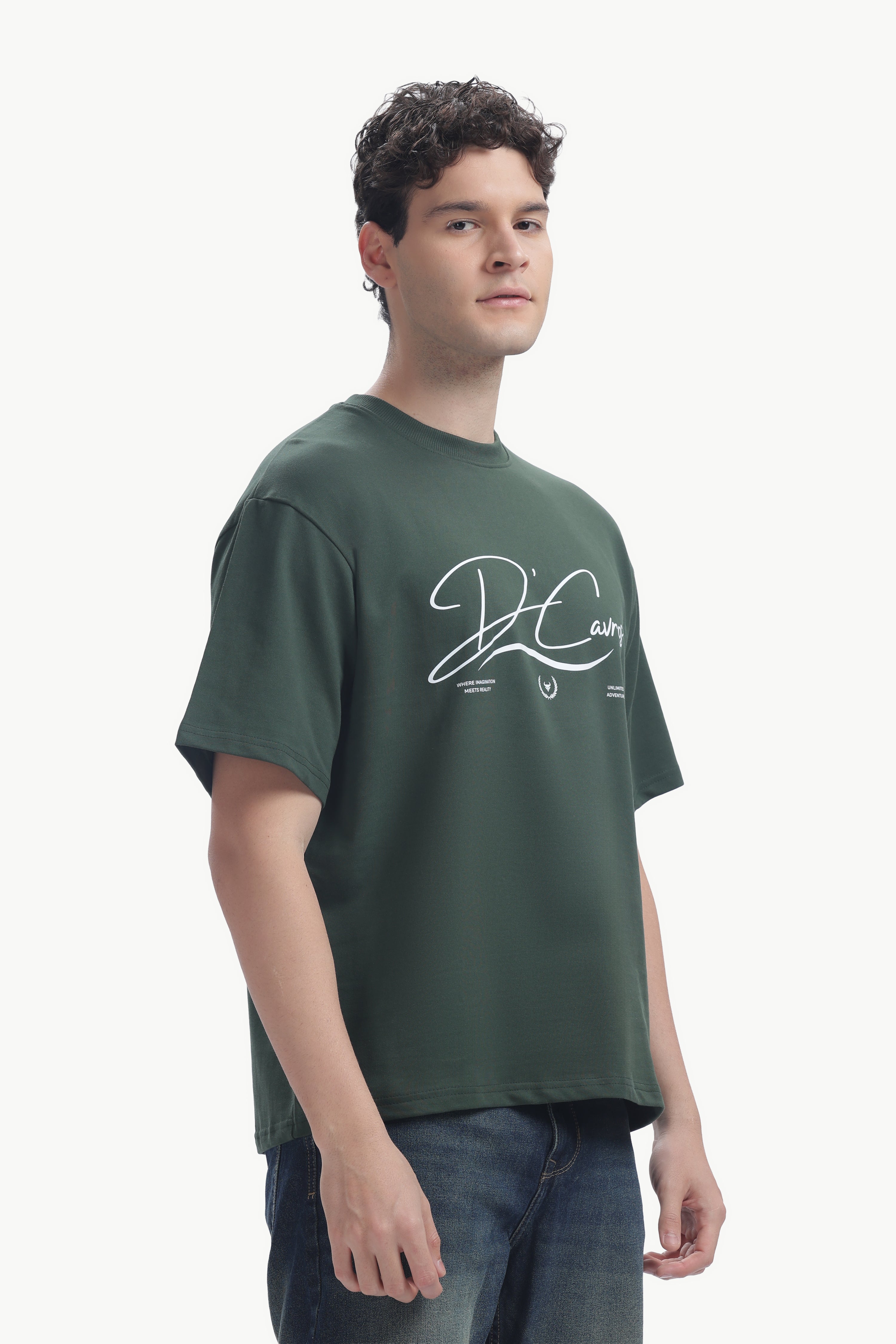 Model wearing Community Capsule Graphics Tee in green with bold typography design.