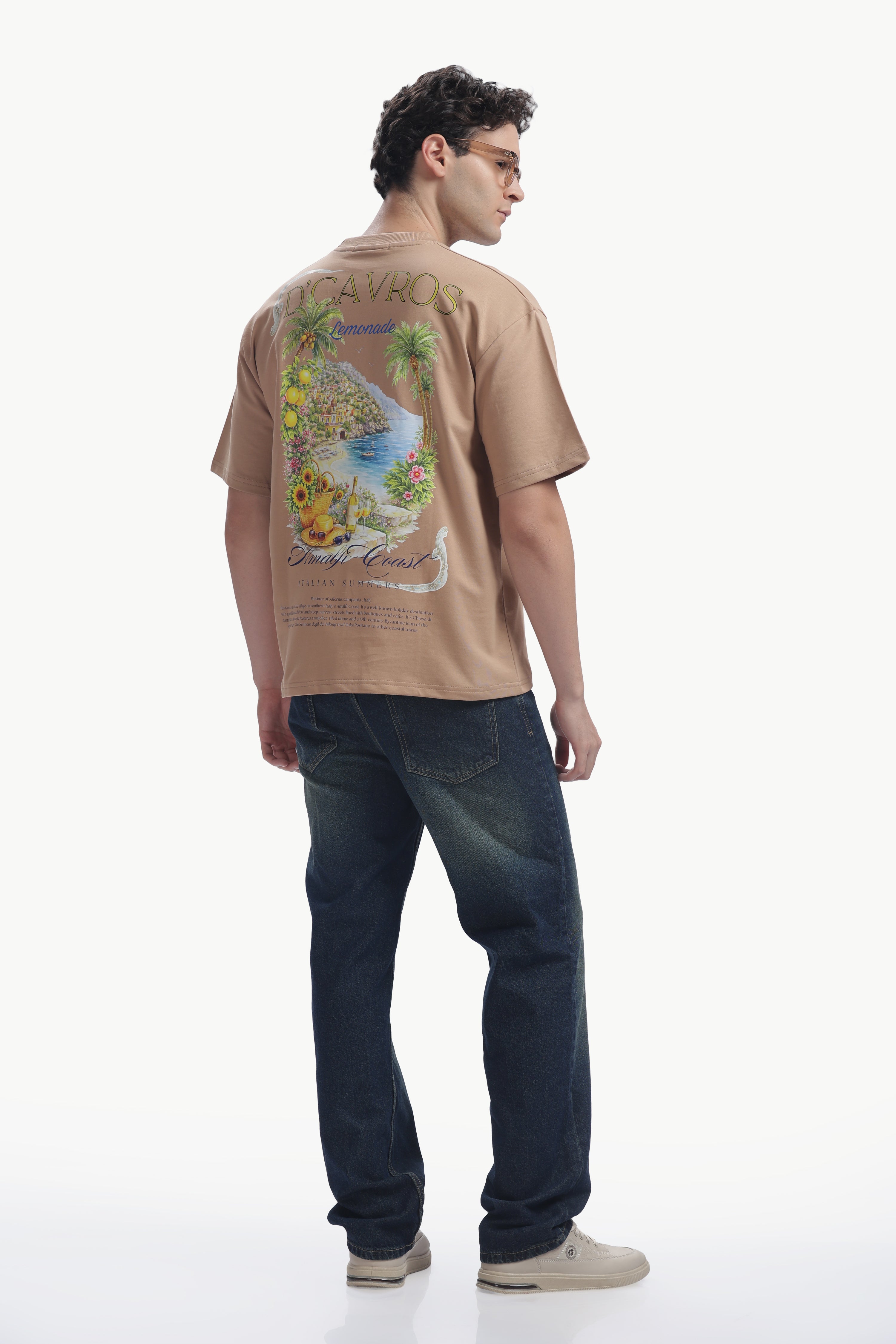 Model wearing an Amalfi coast Oversized Fit T-Shirt showcasing vibrant coastal back print.