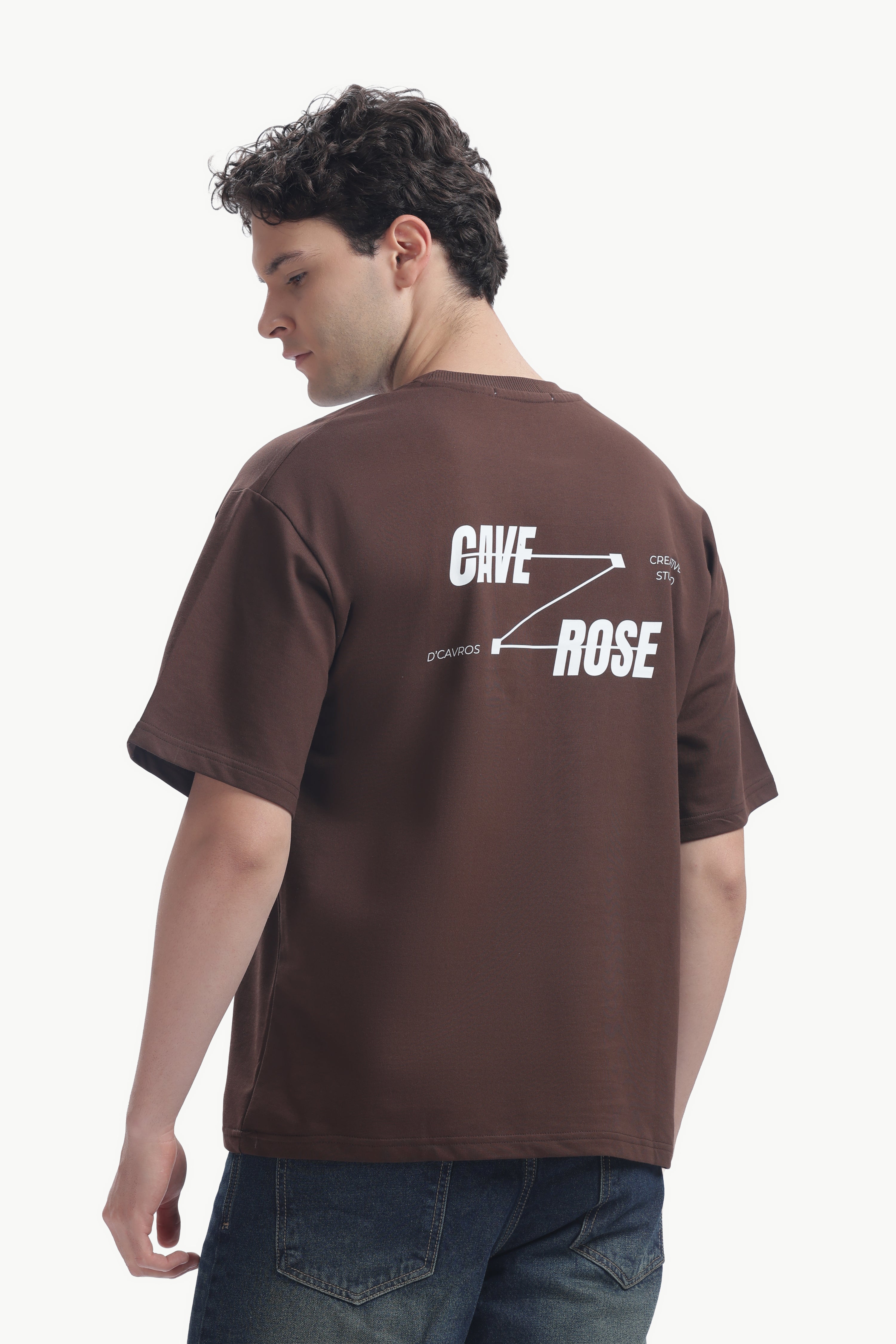 Cave-Rose Creative Studio Graphics Tee featuring bold typography on a brown background.
