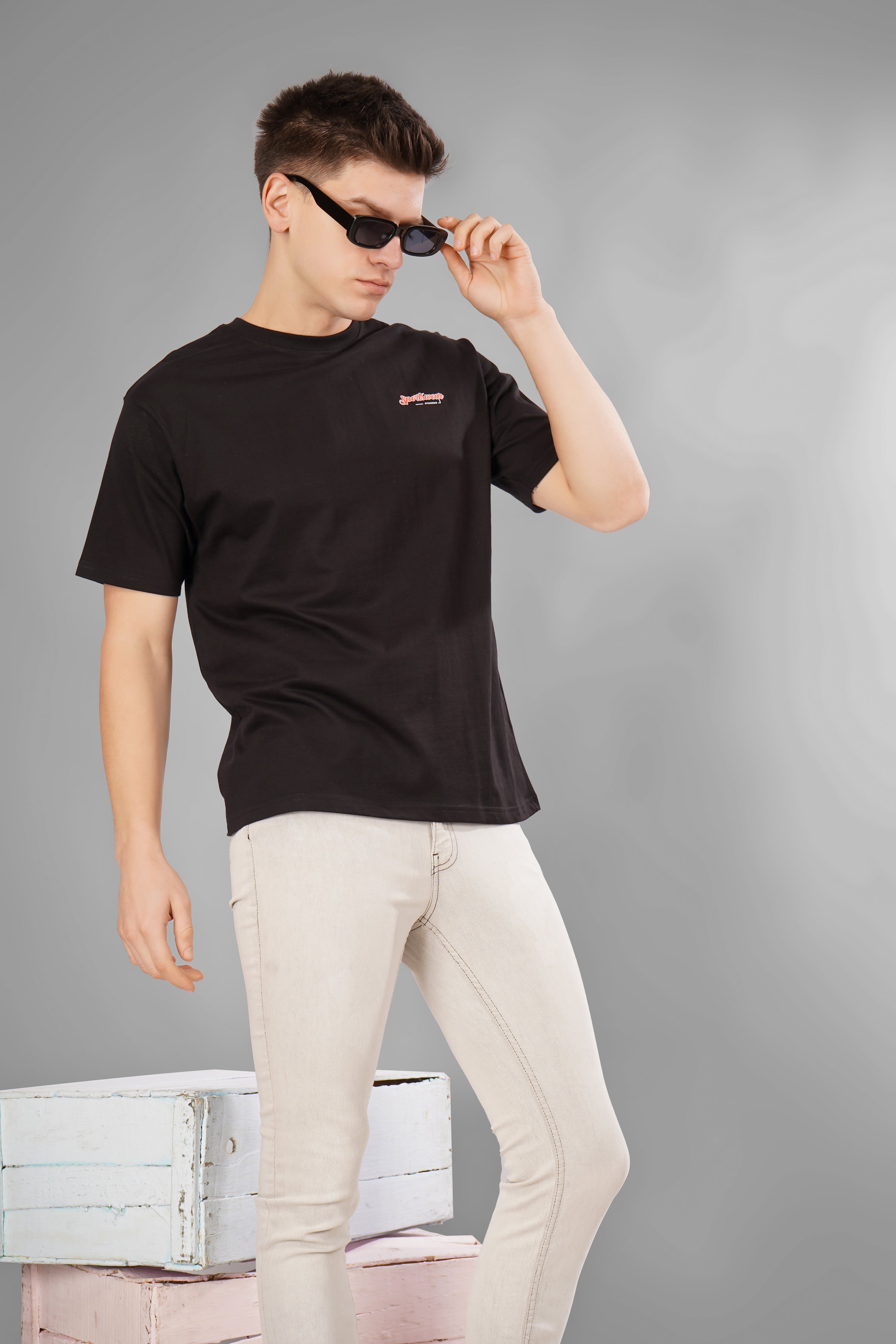 Stylish model wearing a Sports Car Oversized T-Shirt and sunglasses, showcasing relaxed fashion and automotive vibes.