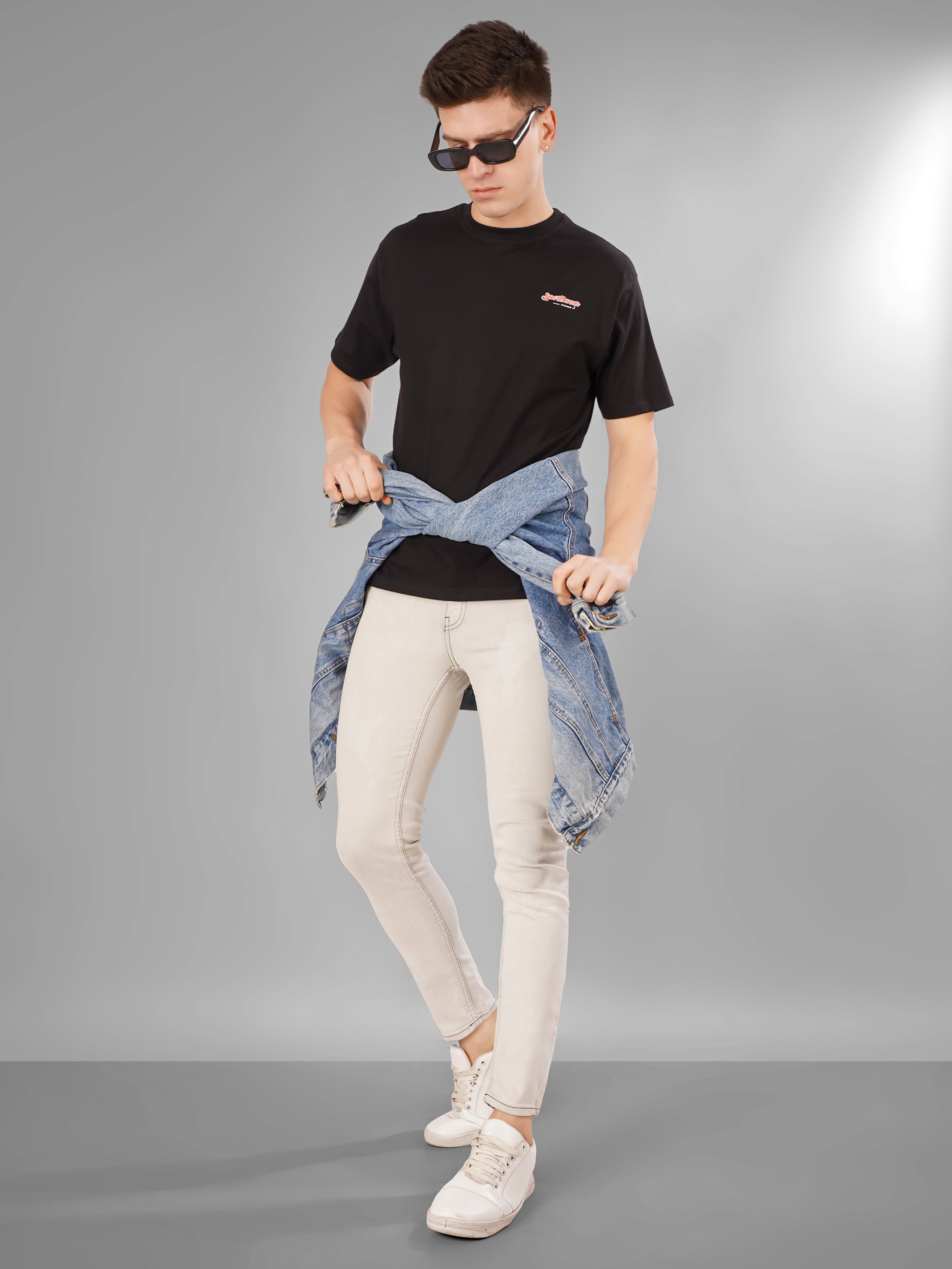 A model wearing a Sports Car Oversized T-Shirt styled with a denim jacket and sunglasses, exuding sporty casual vibes.