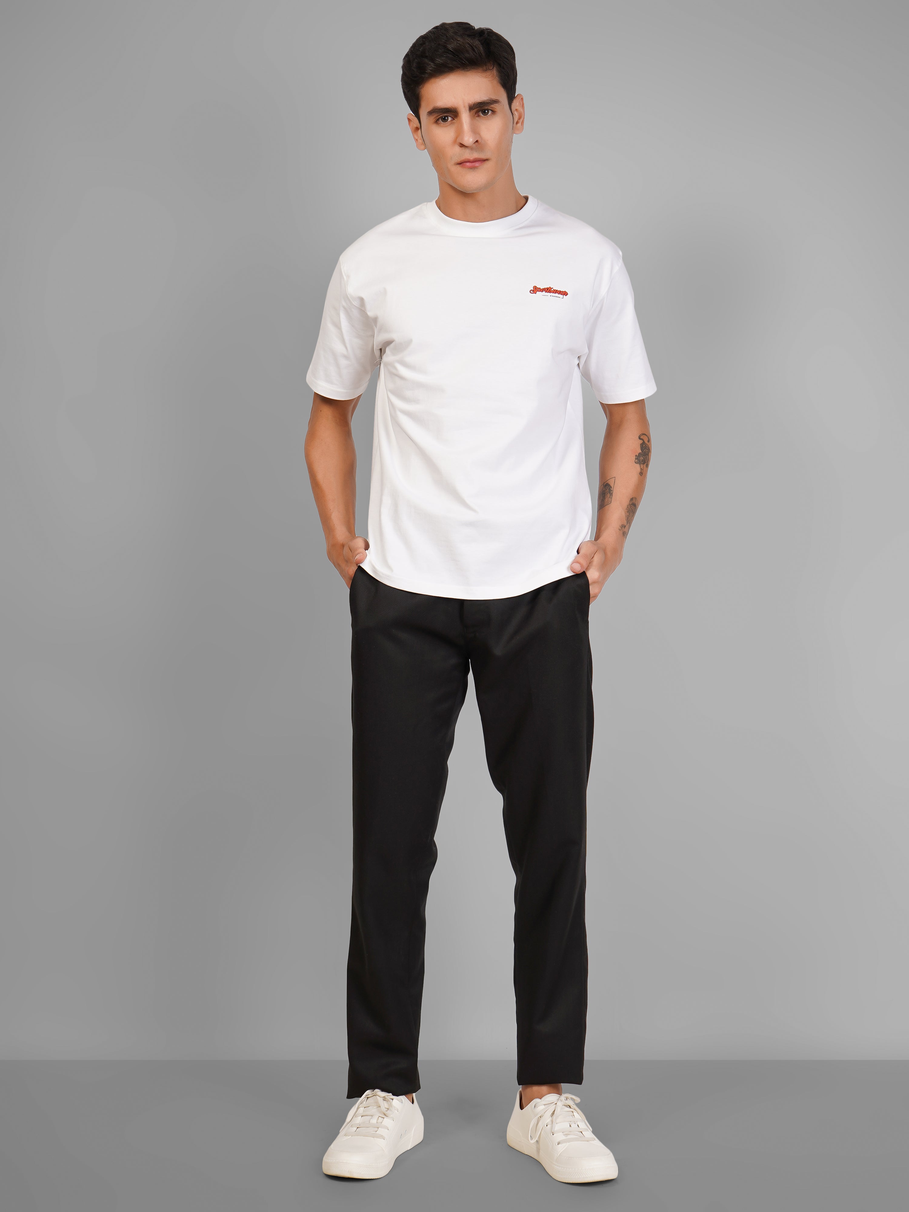 Model wearing a Sports Car Oversized T-Shirt in white with black pants, showcasing casual streetwear style.